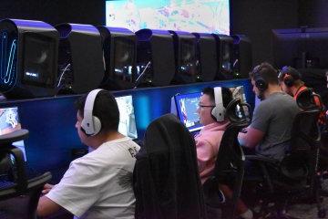 Students in the eSports program, seated in chairs at computer screens in the all-new eSports auditorium.